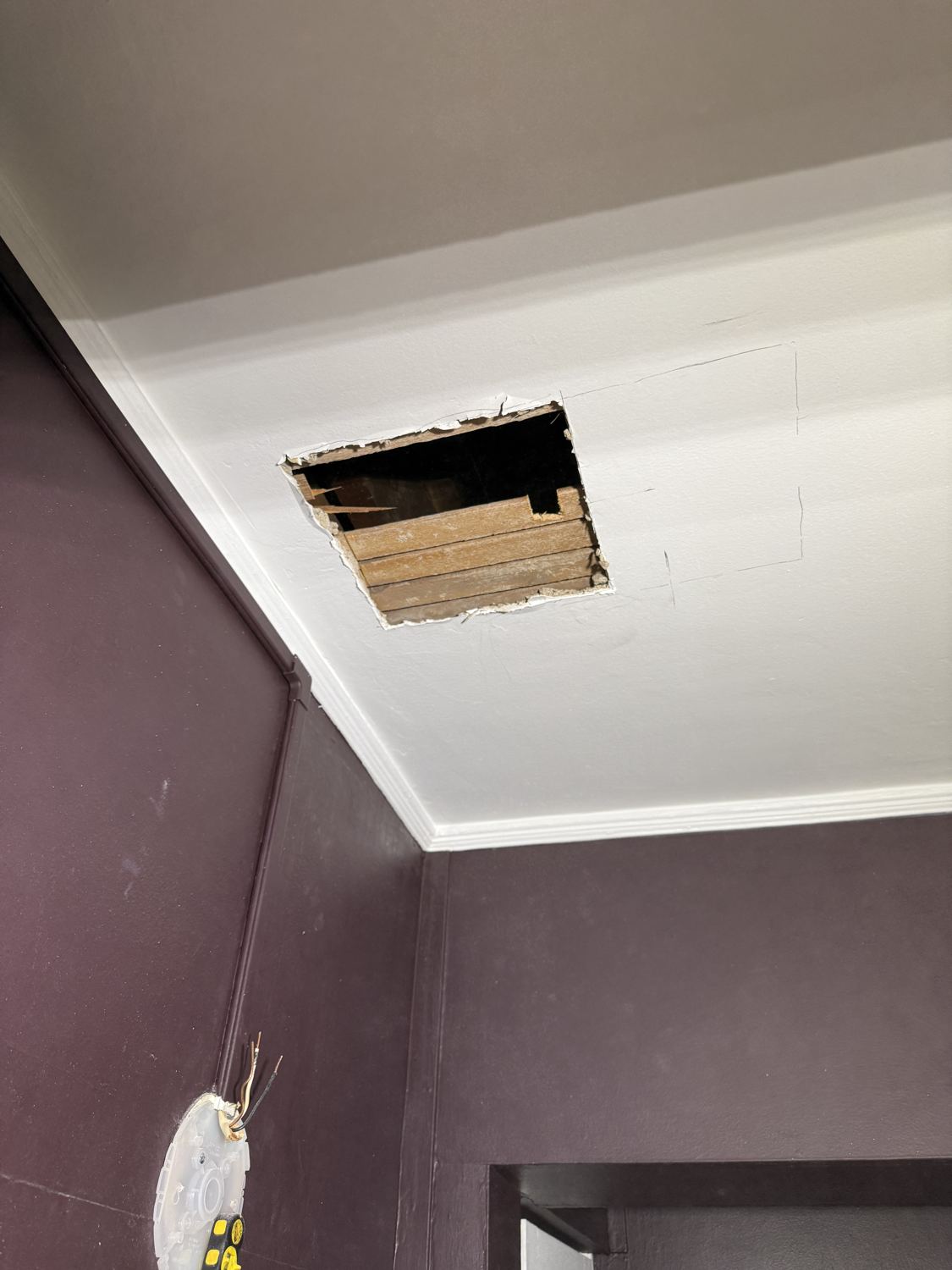 Bathroom ceiling opened after removing the old exhaust fan in a Ho-Ho-Kus, NJ home