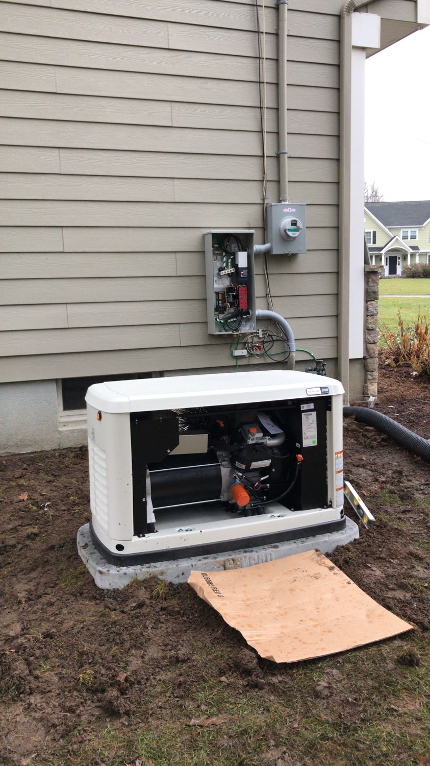 Standby Generac generator installed on its pad beside a home by Fuse Electric in Bergen County, NJ
