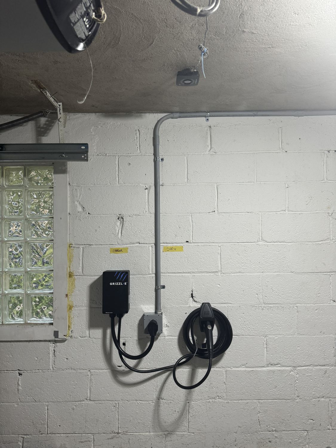 NEMA 14-50 240V EV outlet with a plug-in Grizzl-E Level 2 charger installed by Fuse Electric on a labeled dedicated circuit in a Ridgewood, NJ garage