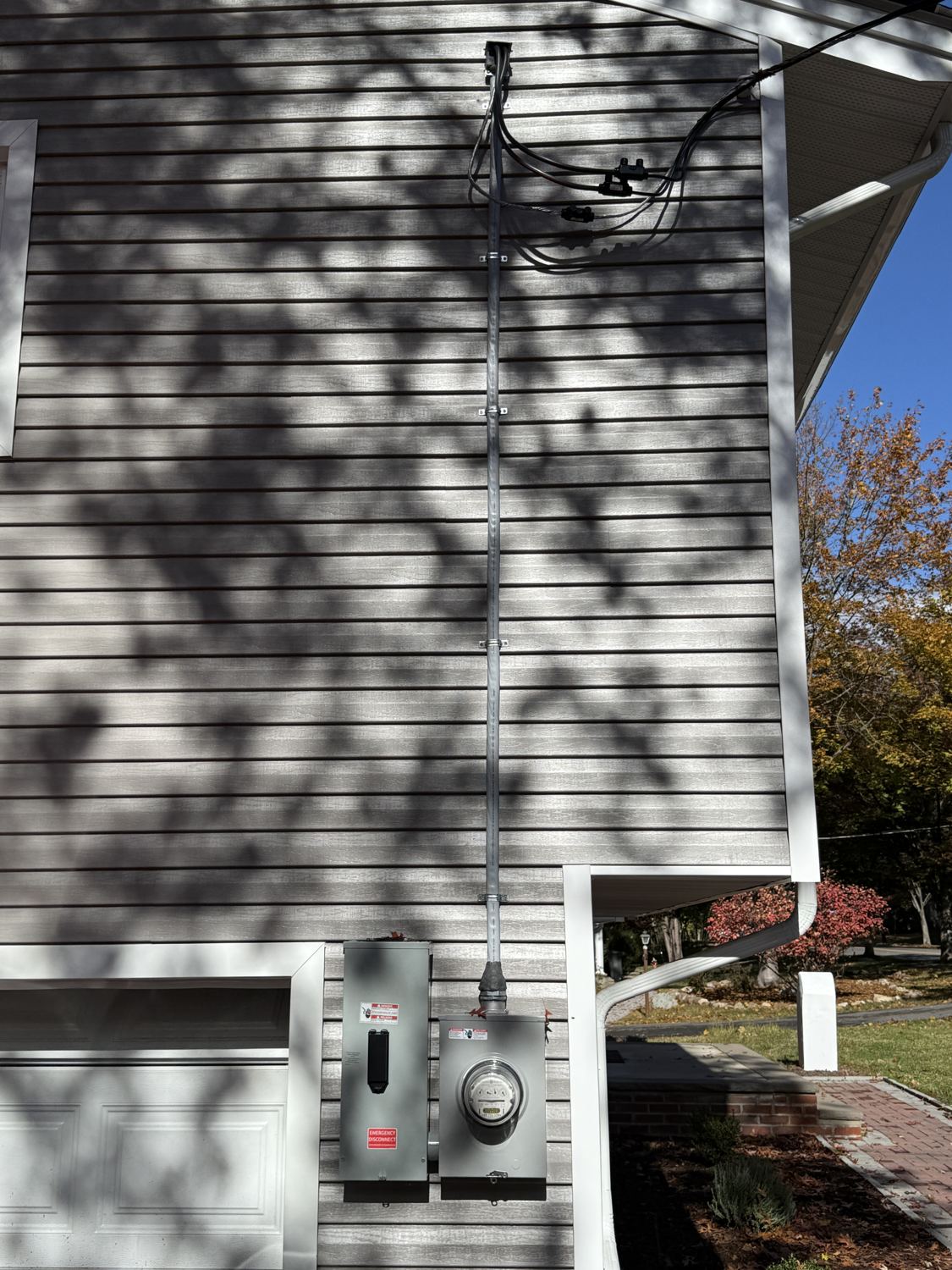 The finished exterior service — new riser and meter — under a clear sky in Park Ridge, NJ